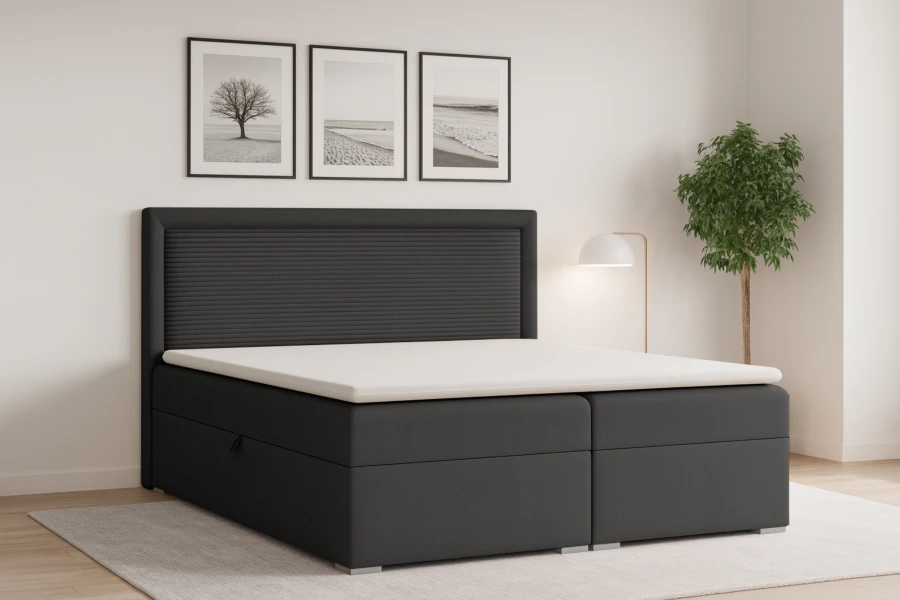Elegantes anthrazitfarbenes Boxspringbett mit hohem Kopfteil und weißem Topper für modernen Schlafkomfort.