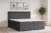 Modernes Boxspringbett in Grau in einem stilvoll eingerichteten Schlafzimmer.
