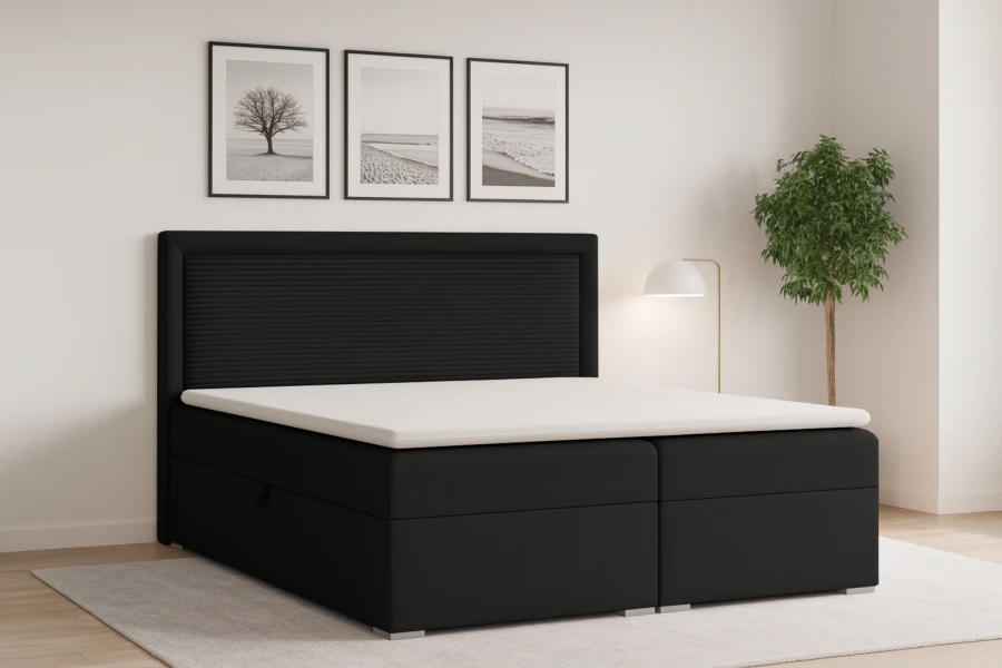 Elegantes Boxspringbett in Schwarz in einem hellen, modern dekorierten Schlafzimmer.