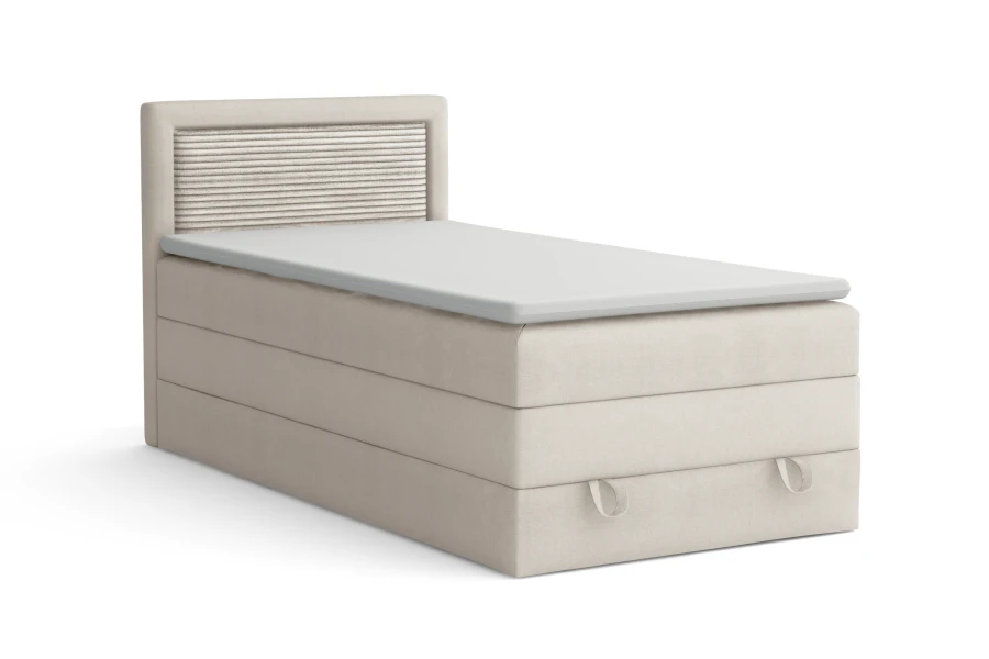 Beiges Einzel-Boxspringbett mit geriffeltem Kopfteil-Einsatz und weißem Topper, isoliert auf Weiß.