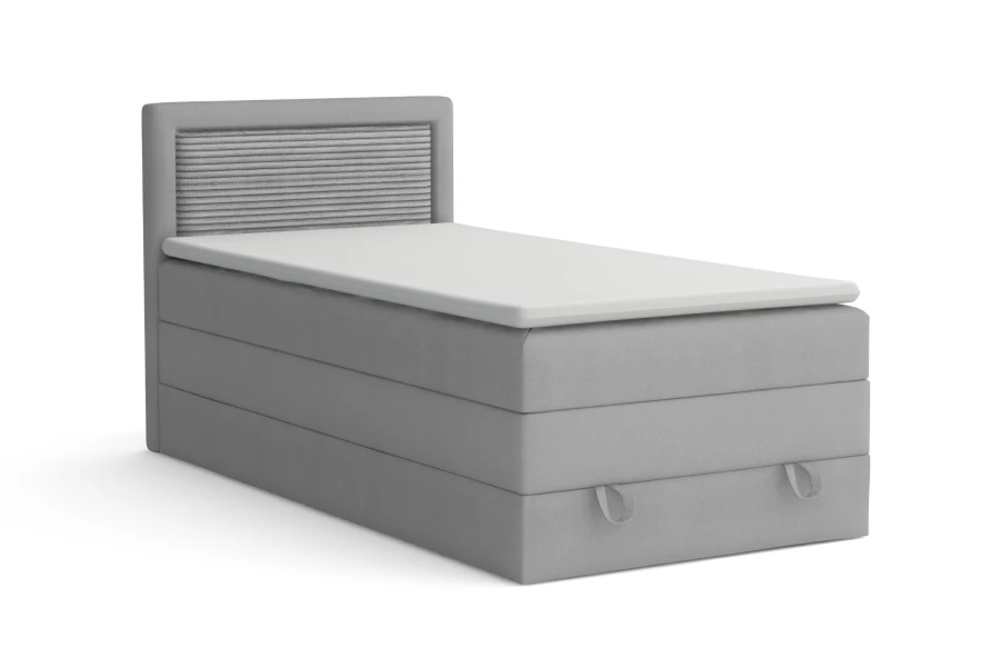 Graues Einzel-Boxspringbett mit gestepptem Kopfteil auf weißem Hintergrund.