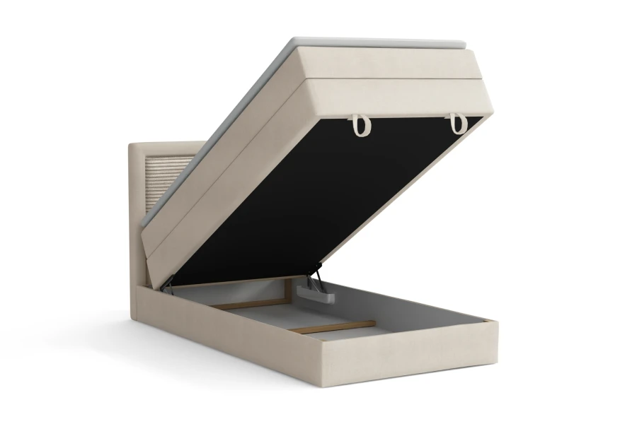 Helles Boxspringbett mit großem, seitlich öffnendem Bettkasten für Stauraum.