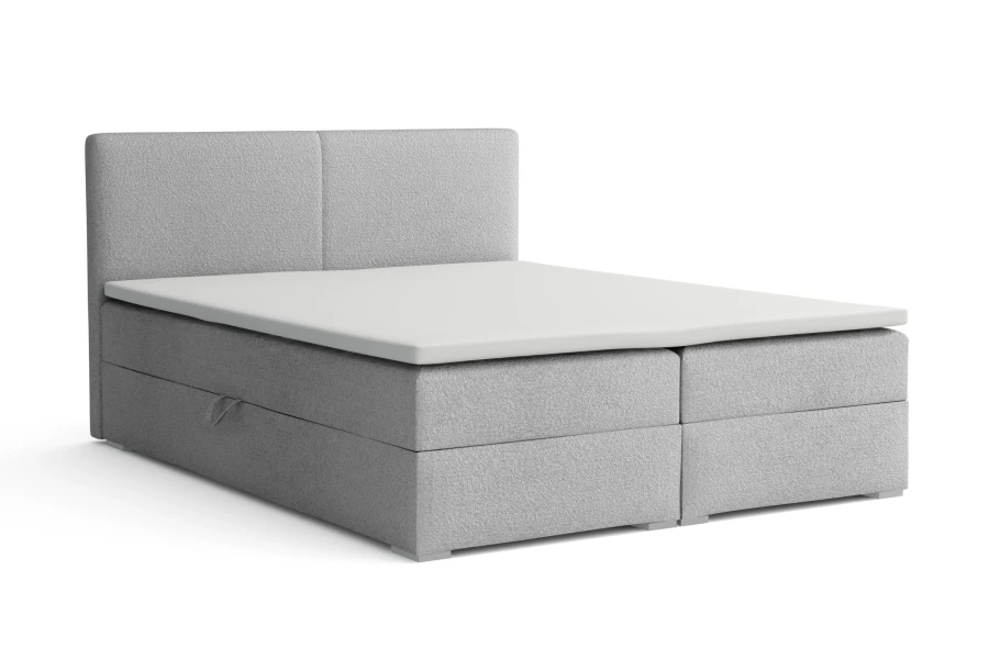 Graues Boxspringbett mit Polster-Kopfteil und weißem Topper
