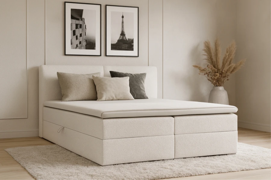Stilvolles Schlafzimmer mit cremefarbenem Boxspringbett und Dekoration