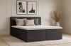 Elegantes schwarzes Boxspringbett im Schlafzimmer-Ambiente mit moderner Dekoration.