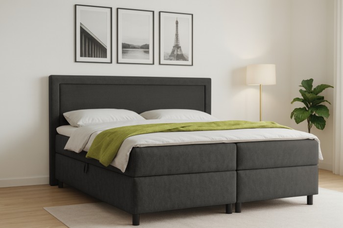 Boxspringbed John in antraciet in een lichte slaapkamer met moderne decoratie.