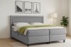 Boxspringbett John im eingerichteten Schlafzimmer mit Wandbildern