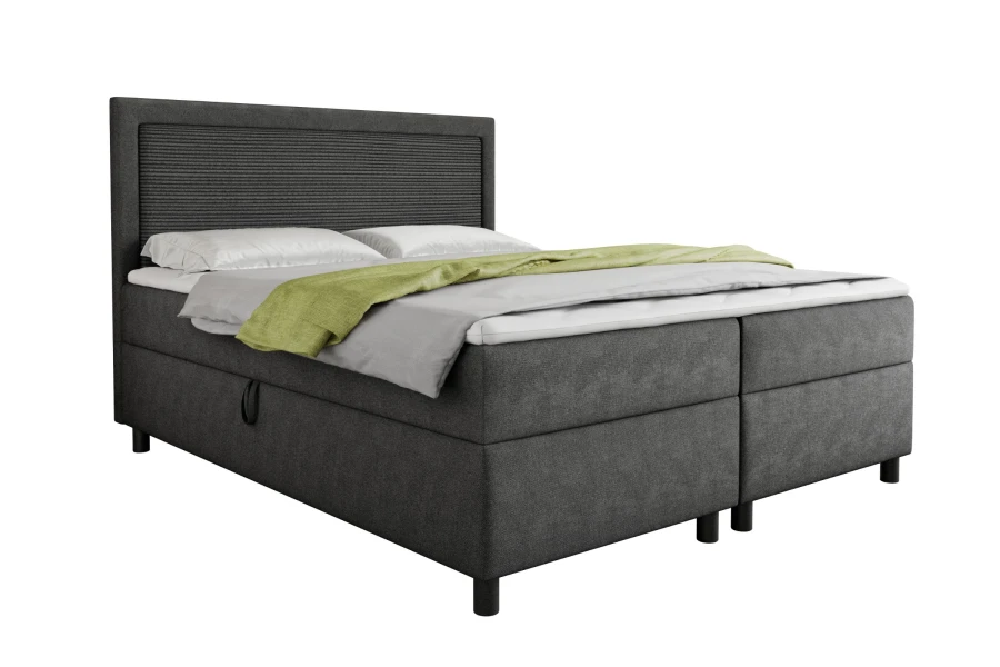 Komfortables anthrazitfarbenes Boxspringbett mit Bettkasten, isoliert auf Weiß.