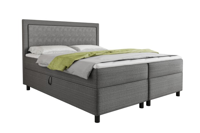 Grijs boxspringbed LARS met corduroy bekleding en gestoffeerd hoofdbord op een witte achtergrond.
