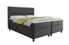Dunkelgraues Boxspringbett in Cord-Optik mit grünem Überwurf