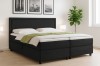 Schwarzes Boxspringbett mit Cord-Stoff und gepolstertem Kopfteil.
