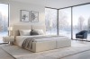 Stilvolles Schlafzimmer mit Polsterbett BEN vor einem großen Fenster mit Schneeblick.