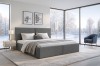Graues Boxspringbett in modernem Schlafzimmer mit Panoramafenstern und Schneelandschaft