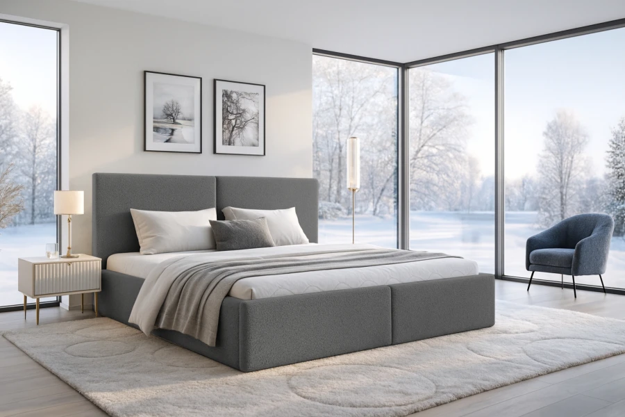 Graues Boxspringbett in modernem Schlafzimmer mit Panoramafenstern und Schneelandschaft