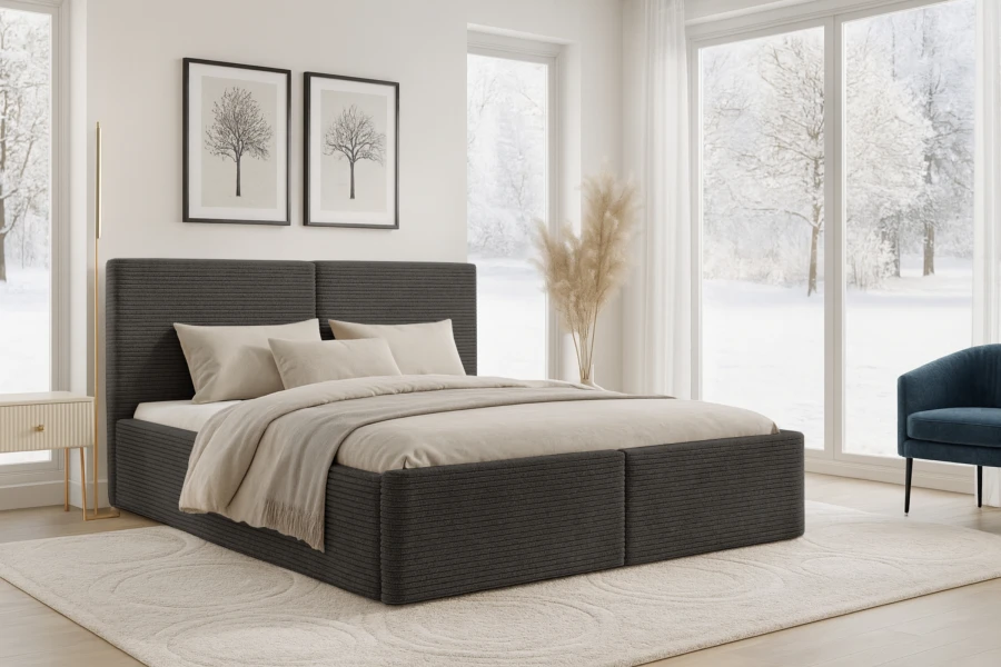 Dunkelgraues Polsterbett mit Cord-Struktur im modernen Schlafzimmer vor winterlicher Kulisse.