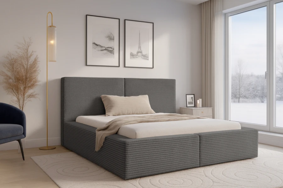 Stilvolles Schlafzimmer mit grauem Boxspringbett, moderner Stehlampe und Teppich.