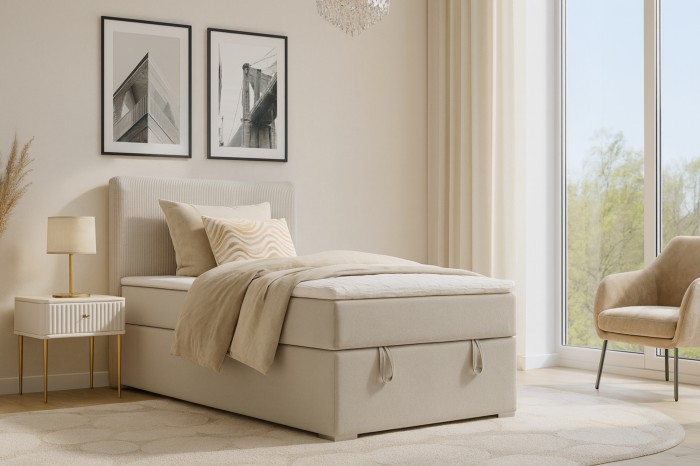 Modern bedroom ambiance with the beige Daga Mini box spring bed and bedside table.