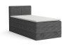 Anthrazitfarbenes Boxspringbett mit Cord-Stoff Poso und weißem Topper vor weißem Hintergrund.