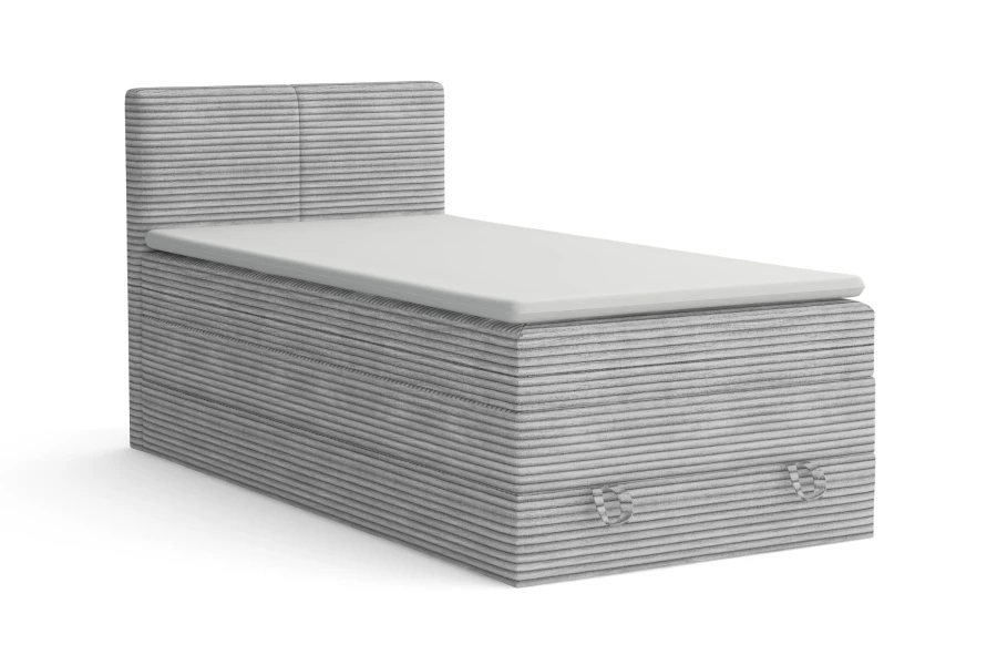 Graues Boxspringbett aus Cord-Stoff mit Kopfteil, freigestellt auf weißem Hintergrund.