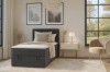 Stijlvolle slaapkamer met antracietkleurig boxspringbed Denis Mini, moderne fauteuil en nachtkastje.