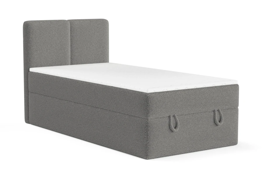 Dunkelgraues Polsterbett als Boxspring-Einzelbett mit Bettkasten-Funktion vor weißem Hintergrund.