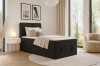 Schwarzes Boxspringbett im modernen Schlafzimmer mit stilvoller Deko.