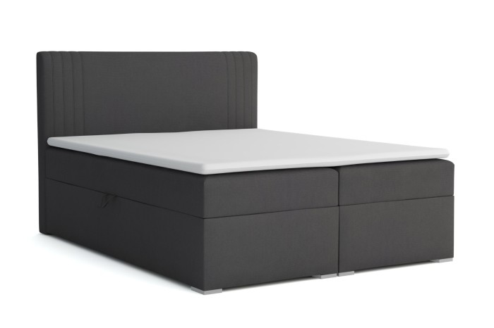 Elegant boxspringbed in antraciet met gecapitonneerd hoofdbord en witte topper in zijaanzicht.