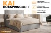 Elegant grijs boxspringbed Kai met praktische beddenbak en topper.