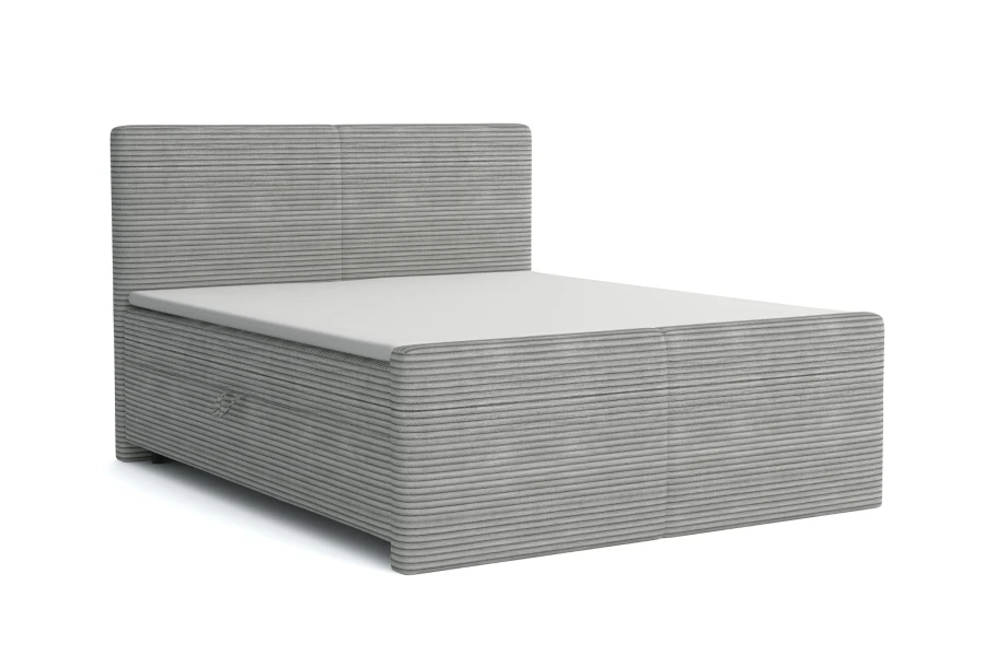Hellgraues Boxspringbett aus Cord-Stoff isoliert auf weißem Hintergrund.