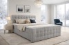 Modernes Boxspringbett in Grau in einem hellen Schlafzimmer mit elegantem Design.