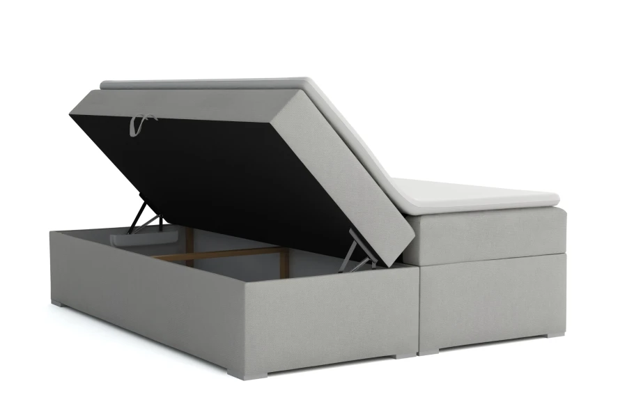 Funktionales Boxspringbett mit geöffnetem Bettkasten für viel Stauraum unter der Matratze.