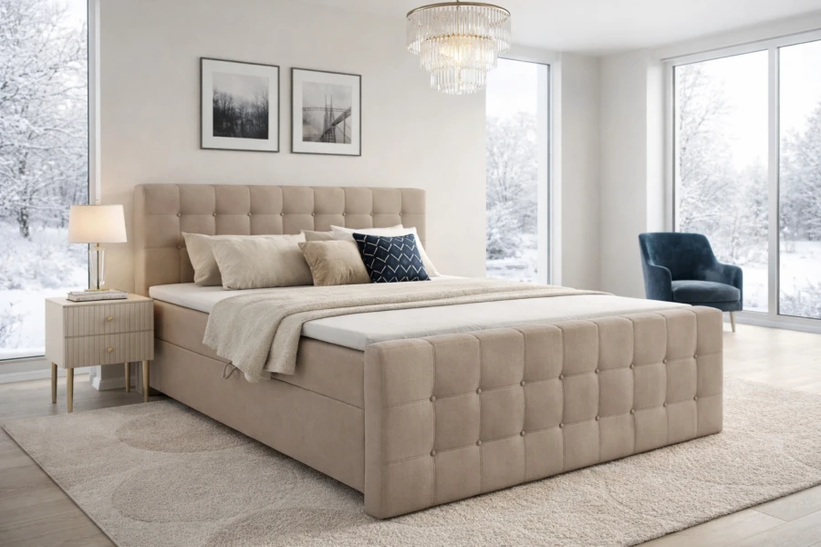 Gemütliches Schlafzimmer mit beigem Boxspringbett und Blick auf Winterlandschaft.