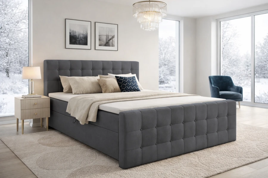 Dunkelgraues Boxspringbett mit Knopfsteppung in einem hellen Schlafzimmer.