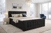 Elegantes schwarzes Boxspringbett in luxuriösem Ambiente mit Winterblick.