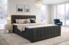 Modernes Boxspringbett in Anthrazit mit gestepptem Kopfteil in winterlichem Schlafzimmer.