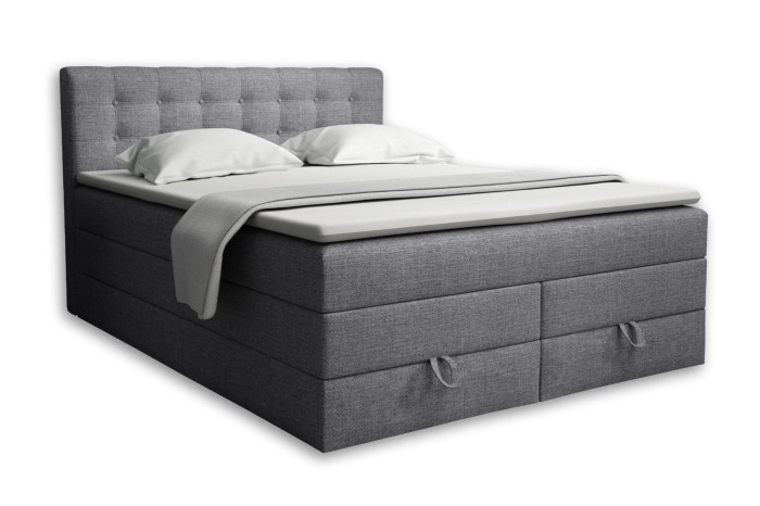 Grijs boxspringbed Verno met gestoffeerd hoofdbord en bedbak op een witte achtergrond.