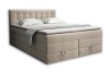 Elegantes beiges Boxspringbett mit Steppung am Kopfteil freigestellt auf weißem Hintergrund.