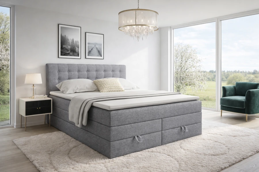Graues Boxspringbett mit Bettkasten in modernem, hellem Schlafzimmer.