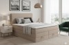 Modernes Boxspringbett in Beige mit Bettkasten im hellen Schlafzimmer.