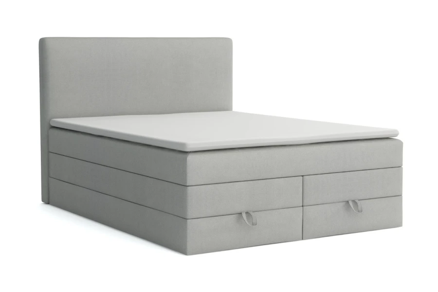 Hellgraues Boxspringbett mit Schubladen freigestellt auf weißem Grund.
