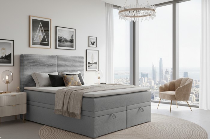 Boxspringbed Daniel in een moderne slaapkamer met uitzicht op de skyline, fauteuil en stijlvolle wanddecoratie.