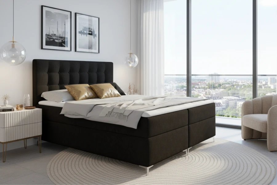 Modernes Boxspringbett in Anthrazit in einem hellen Schlafzimmer mit Stadtblick und Sessel