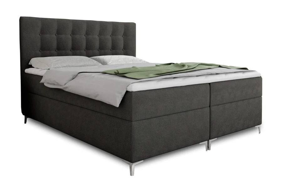 Seitenansicht eines anthrazitfarbenen Boxspringbetts mit bequemer Polsterung und Bettwäsche
