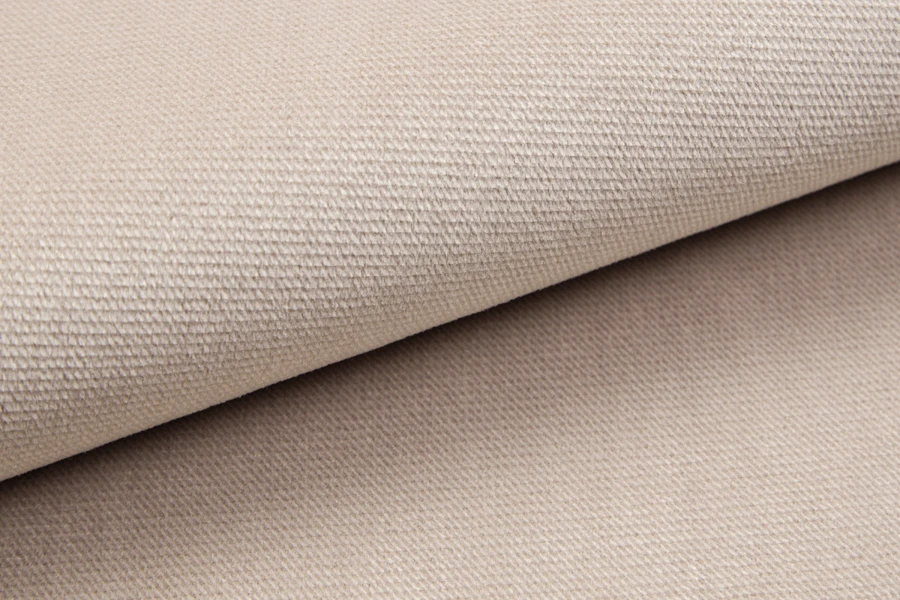 Close-up of the beige textile structure of the boxspring bed cover.