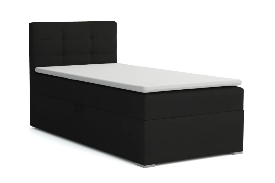 Zwart boxspringbed met gestoffeerd hoofdbord en witte topper op een witte achtergrond.