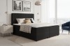 Modernes schwarzes Boxspringbett in hellem Schlafzimmer mit Stadtblick.