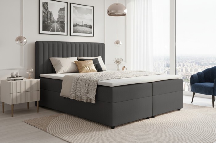 Dunkelgraues Boxspringbett in modernem Schlafzimmer-Ambiente.