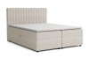 Beiges Boxspringbett mit vertikal gestepptem Kopfteil.