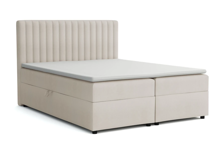 Beiges Boxspringbett mit vertikal gestepptem Kopfteil.
