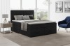 Modernes dunkelgraues Boxspringbett in Cord-Optik im stilvoll eingerichteten Schlafzimmer.